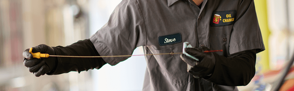 Take 5 technician checking oil