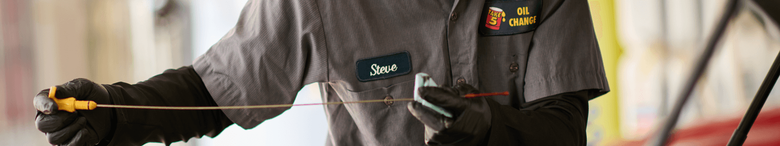 Take 5 technician checking oil